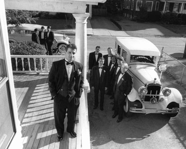 groom and groomsmen with antique cars